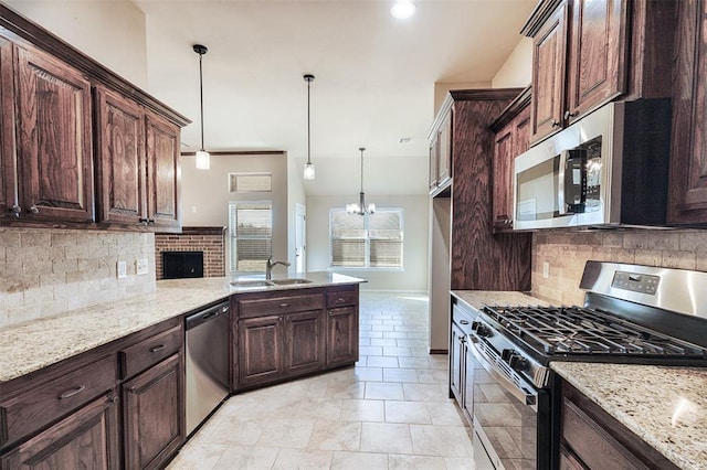 kitchen featuring pendant lighting, stainless steel appliances, and dark brown cabinets