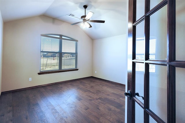 spare room featuring dark hardwood / wood-style flooring, vaulted ceiling, and ceiling fan