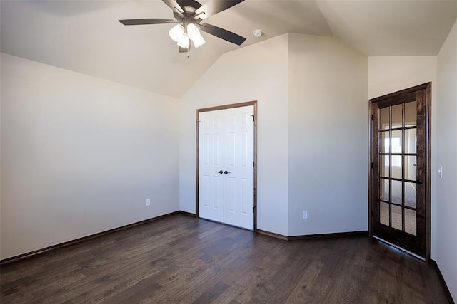 unfurnished bedroom featuring ceiling fan, dark hardwood / wood-style flooring, lofted ceiling, and a closet