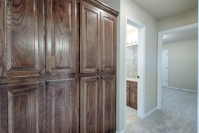 hallway featuring light carpet