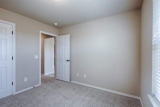 unfurnished bedroom with light carpet