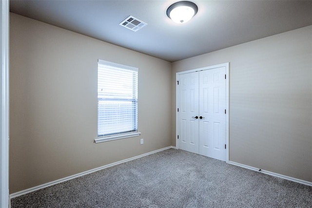 unfurnished bedroom with carpet flooring and a closet