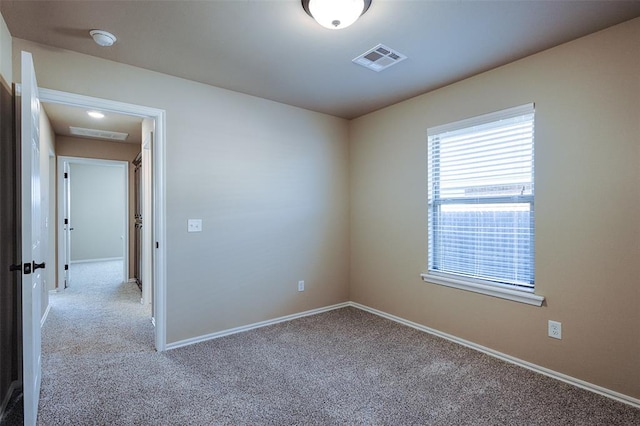 unfurnished room with light colored carpet