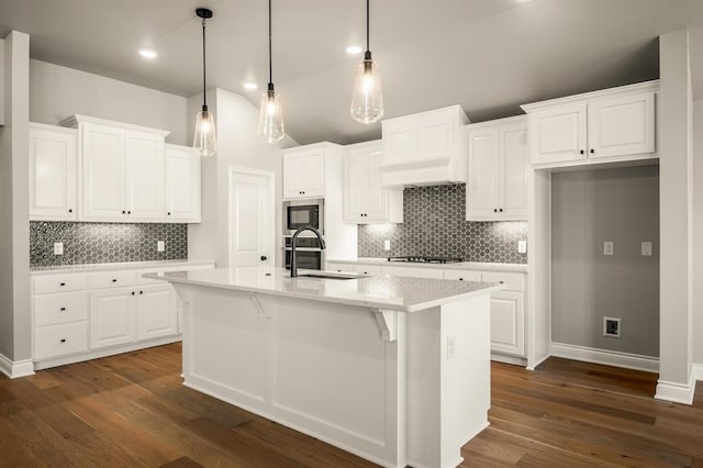 kitchen featuring a center island with sink, white cabinetry, and sink