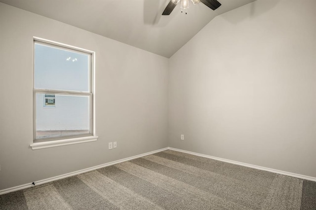 carpeted empty room featuring ceiling fan and vaulted ceiling