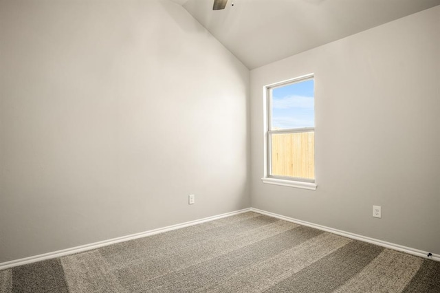 unfurnished room featuring ceiling fan, carpet floors, and vaulted ceiling