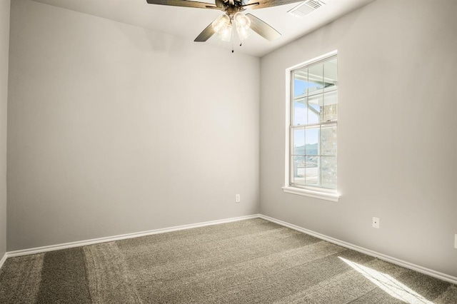 empty room featuring carpet, ceiling fan, and a wealth of natural light