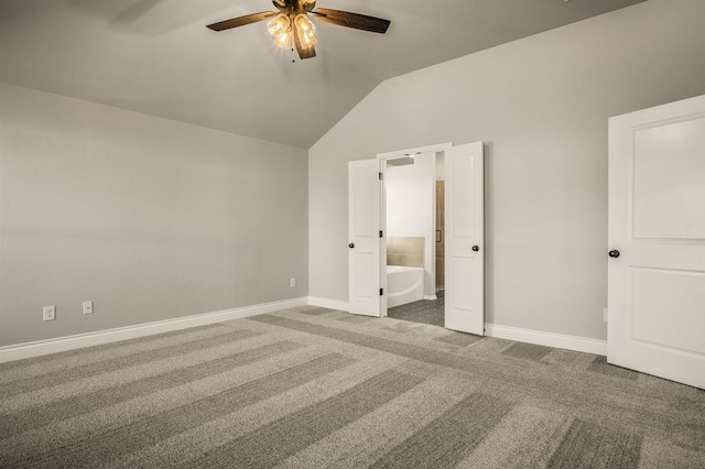 unfurnished bedroom with carpet, connected bathroom, vaulted ceiling, and ceiling fan