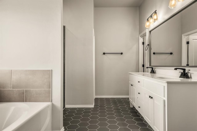 bathroom featuring tile patterned floors, a bathing tub, and vanity