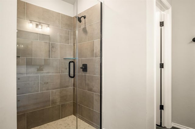 bathroom featuring a shower with door