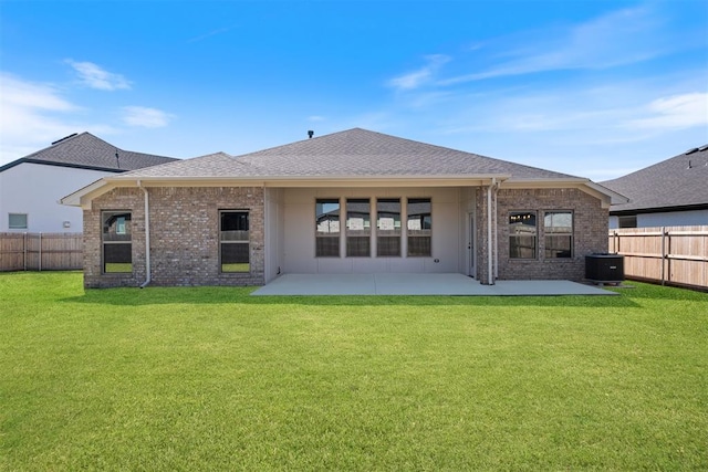 rear view of property with a yard, a patio, and central air condition unit