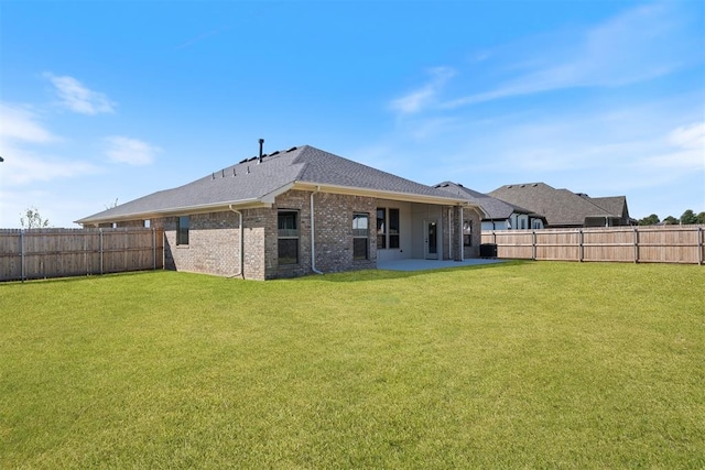 back of property featuring a lawn and a patio area