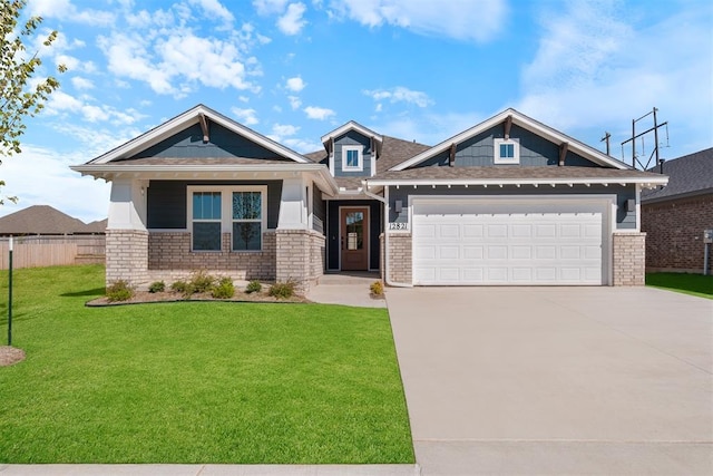 craftsman inspired home featuring a garage and a front lawn