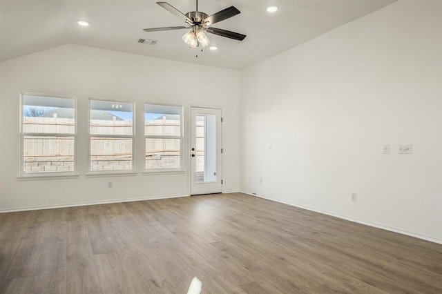 unfurnished room with ceiling fan, hardwood / wood-style floors, and lofted ceiling