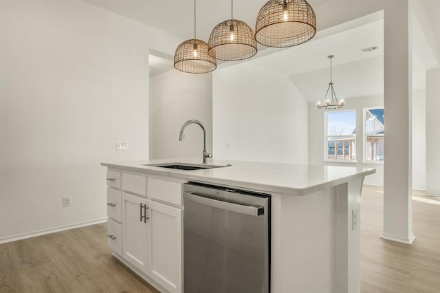 kitchen featuring white cabinetry, dishwasher, sink, pendant lighting, and a center island with sink