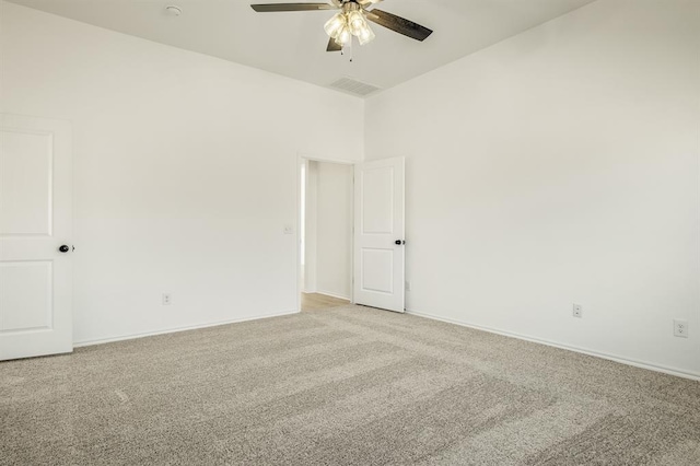 carpeted empty room featuring ceiling fan