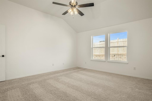 spare room featuring ceiling fan, carpet floors, and lofted ceiling