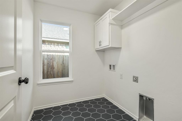 clothes washing area with cabinets, hookup for a washing machine, and electric dryer hookup