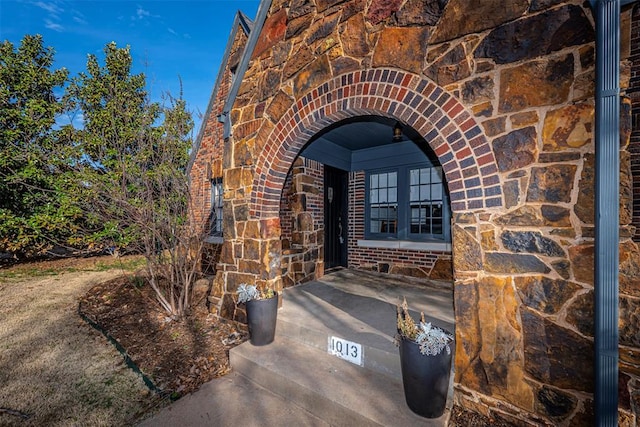 property entrance featuring brick siding