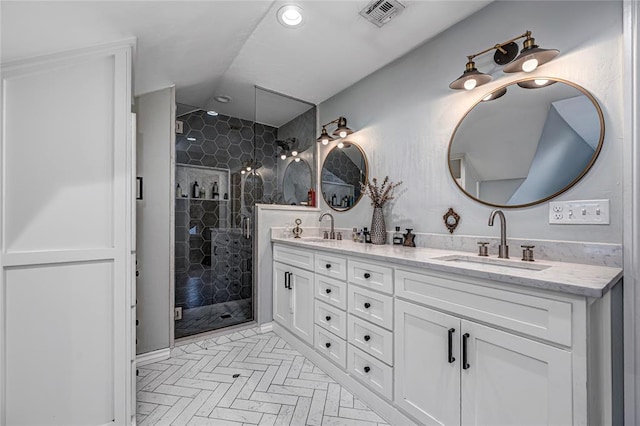 bathroom featuring a sink, visible vents, a shower stall, and double vanity