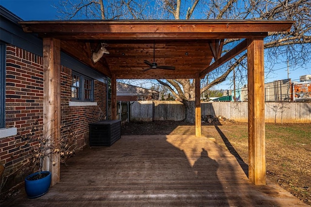 deck with ceiling fan and fence