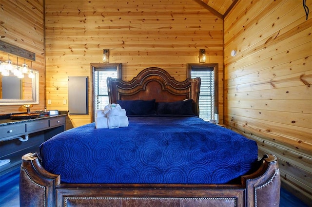 bedroom featuring vaulted ceiling and wooden walls