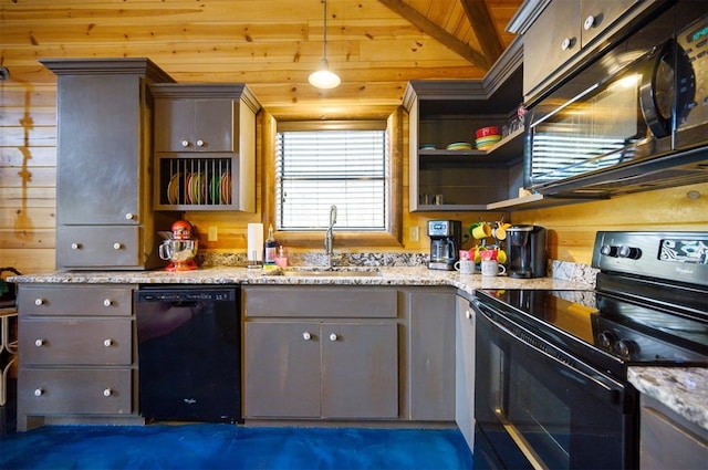 kitchen with light stone countertops, sink, hanging light fixtures, lofted ceiling with beams, and black appliances