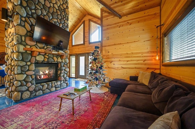 living room with wood walls, a fireplace, high vaulted ceiling, and wooden ceiling