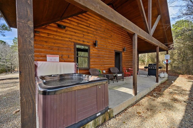 view of patio / terrace featuring a grill and a hot tub