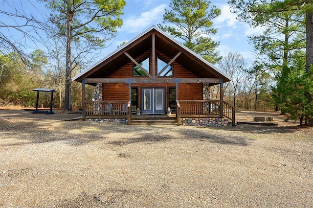 log cabin with french doors and covered porch