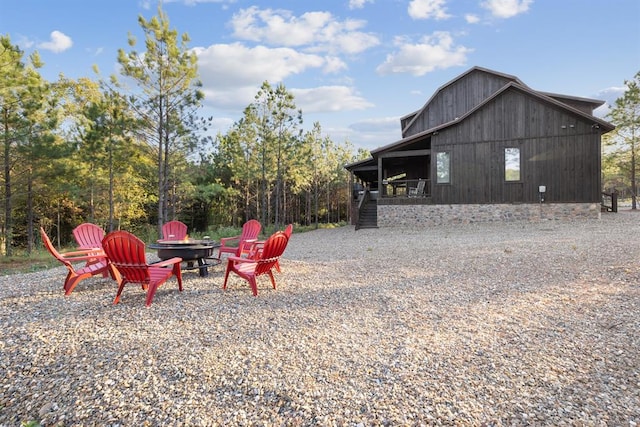 view of yard with an outdoor structure and an outdoor fire pit