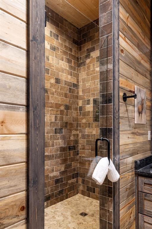 bathroom with wooden walls and tiled shower