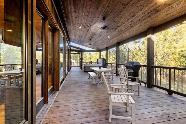 wooden deck featuring a grill