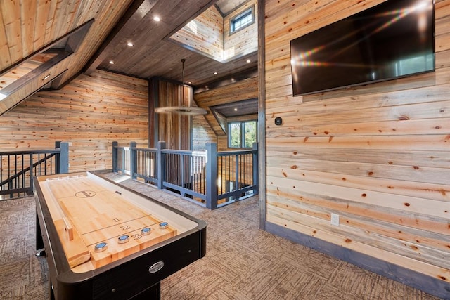 rec room featuring a skylight, wooden ceiling, and wood walls