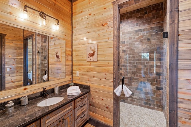 bathroom featuring wood walls and vanity