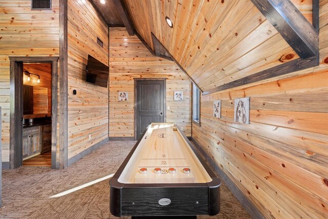 game room featuring wood ceiling, wood walls, dark carpet, and lofted ceiling