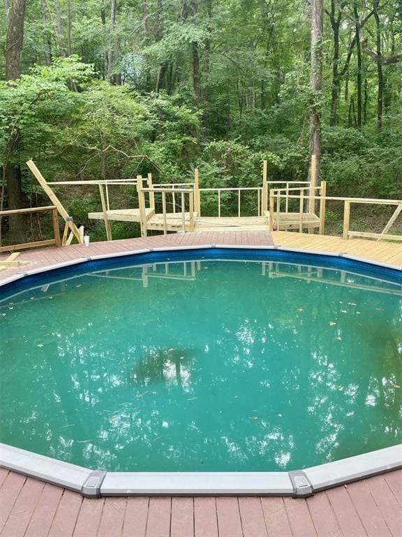 view of swimming pool with a wooden deck