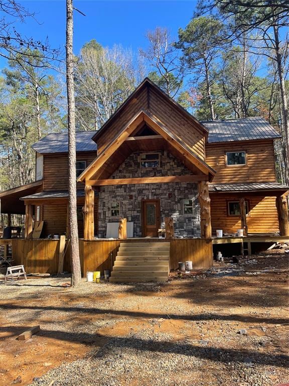 log-style house with covered porch