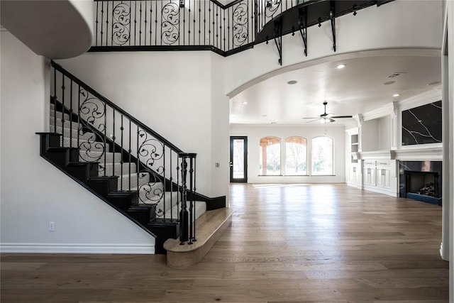 5900 N Choctaw Rd, Choctaw, OK 73020 - entrance foyer featuring ceiling fan, wood finished floors, stairway, a towering ceiling, and crown molding