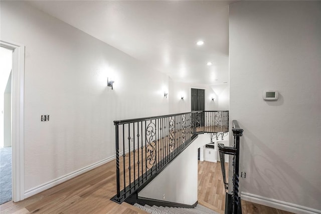 staircase featuring wood-type flooring