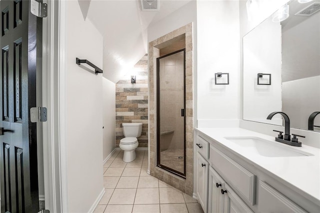 bathroom with tile patterned flooring, vanity, a shower with door, and toilet