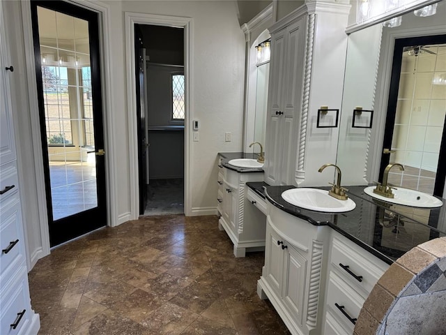 5900 N Choctaw Rd, Choctaw, OK 73020 - full bath with two vanities, plenty of natural light, and stone finish floors