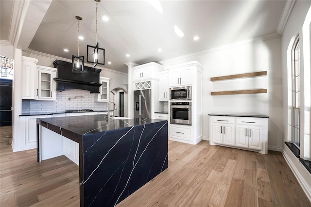 5900 N Choctaw Rd, Choctaw, OK 73020 - kitchen featuring appliances with stainless steel finishes, dark countertops, decorative backsplash, crown molding, and light wood-style floors