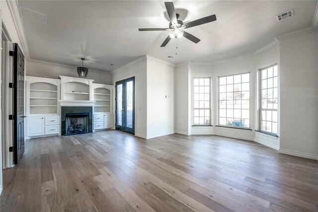 5900 N Choctaw Rd, Choctaw, OK 73020 - unfurnished living room with light wood-style floors, ceiling fan, a fireplace, and crown molding