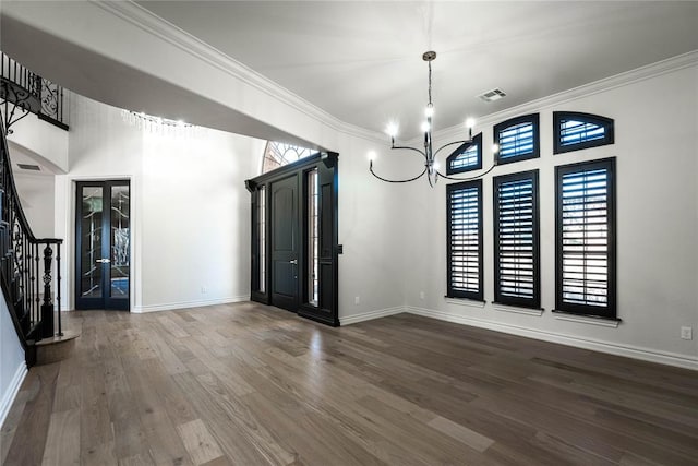 5900 N Choctaw Rd, Choctaw, OK 73020 - unfurnished dining area featuring stairs, crown molding, wood finished floors, a chandelier, and a towering ceiling