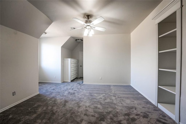 bonus room featuring ceiling fan, vaulted ceiling, and dark colored carpet