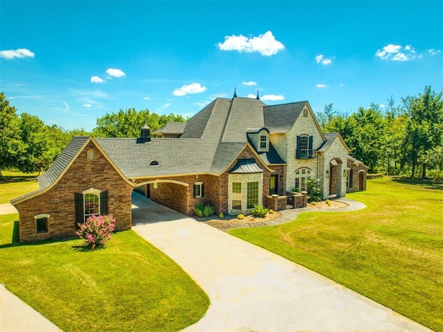 5900 N Choctaw Rd, Choctaw, OK 73020 - french provincial home with stone siding, concrete driveway, a front lawn, a carport, and roof with shingles