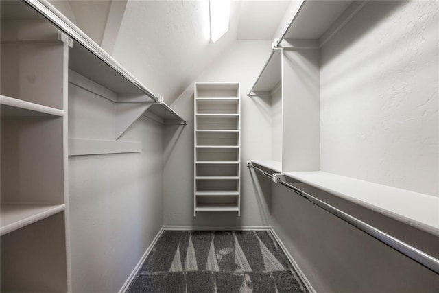 5900 N Choctaw Rd, Choctaw, OK 73020 - spacious closet featuring dark colored carpet and lofted ceiling