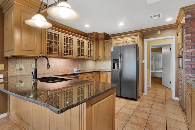 kitchen with pendant lighting, sink, appliances with stainless steel finishes, light tile patterned flooring, and kitchen peninsula