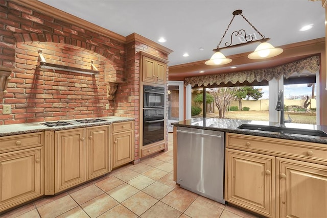 kitchen with a wealth of natural light, hanging light fixtures, sink, and appliances with stainless steel finishes